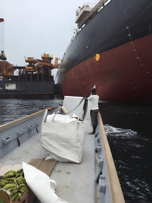 Chamax Marine Services boat delivering provisions to a vessel at anchorage in Gabon